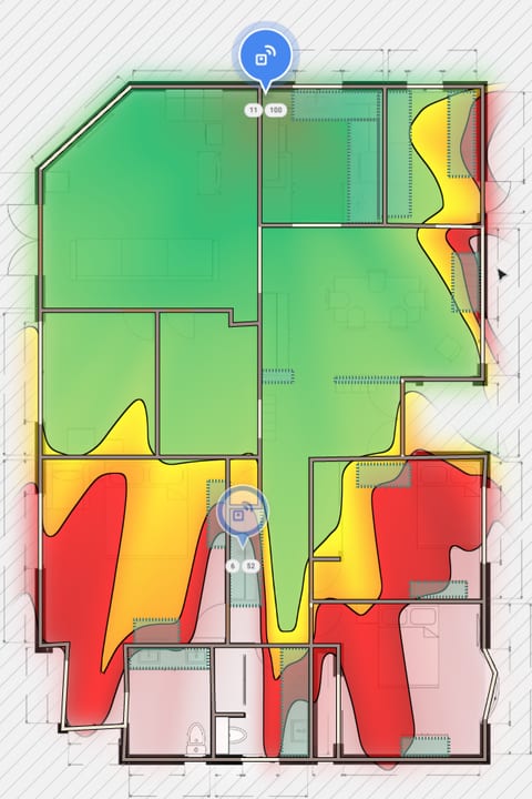 Planning view with two access points placed: coverage from the access point by the kitchen, green across the front half of the home.